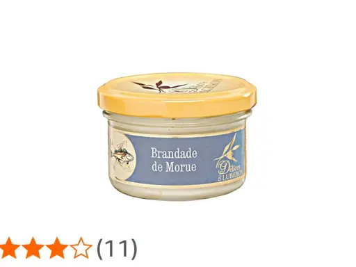 Glas mit Brandade de Morue, einer cremigen Kabeljaupaste, mit einem Fischmotiv auf dem Etikett.