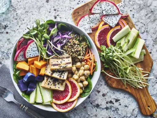 Bunter Buddha Bowl mit Tofu, Quinoa, Süßkartoffeln, Drachenfrucht und Sprossen – perfekt für das leichte essen an warmen tagen.