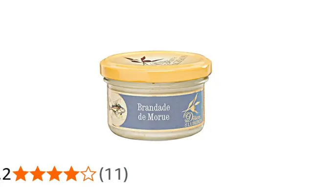Glas mit Brandade de Morue, einer cremigen Kabeljaupaste, mit einem Fischmotiv auf dem Etikett.