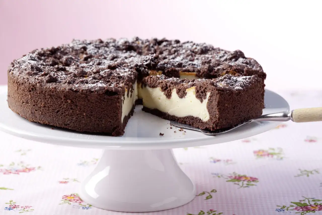 Ein saftiger russischer Zupfkuchen mit Schokoladenstreuseln und cremiger Füllung, bereit zum Servieren.